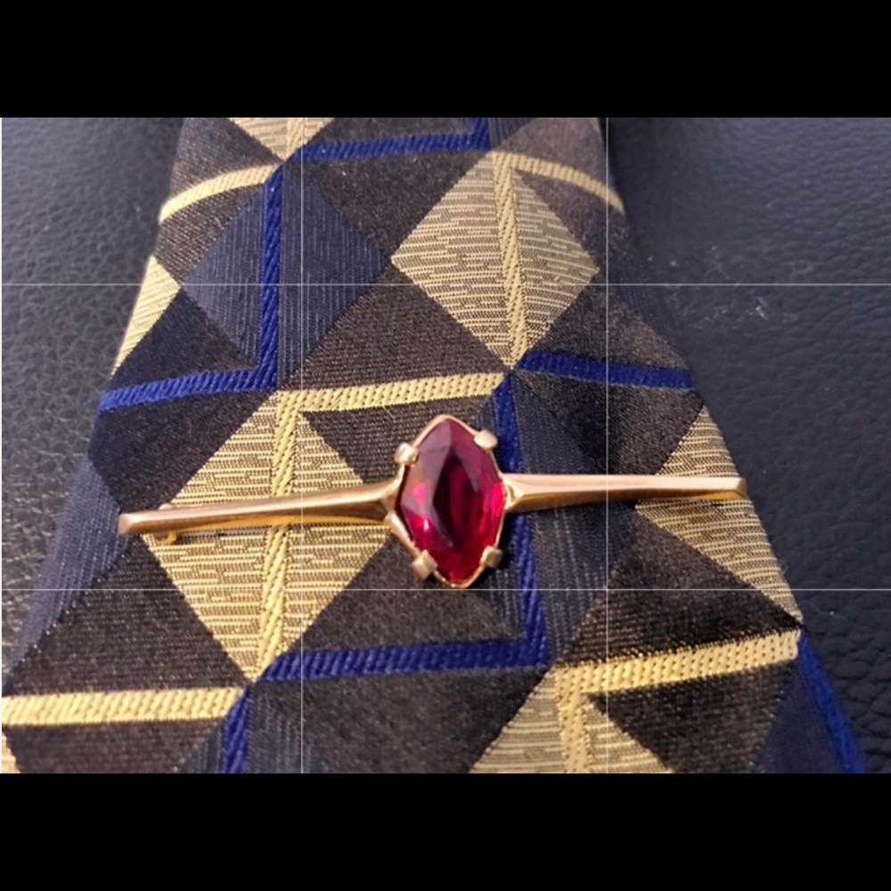 Gold tie bar lapel pin with large synthetic ruby